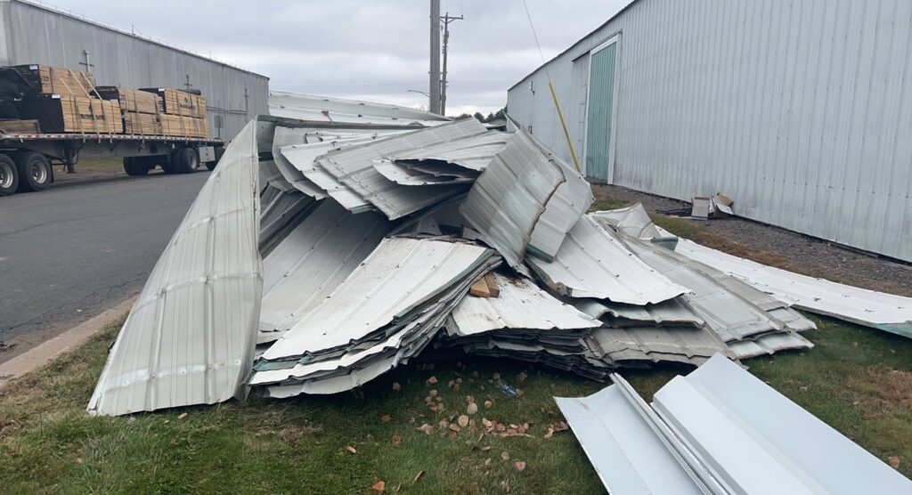 A large pile of corrugated metal sheets ready for debris removal by Cash For Scrap Vehicles / Junk Removal in Minneapolis, MN.