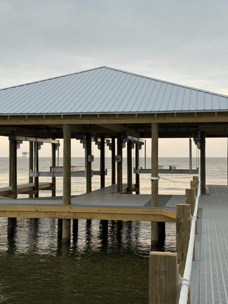 Exterior view of a newly constructed covered boat dock by Payne's Marine Service, LLC in Fairhope, AL