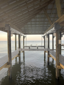 A newly constructed covered boat dock with multiple boat lifts installed by Payne's Marine Service, LLC in Fairhope, AL