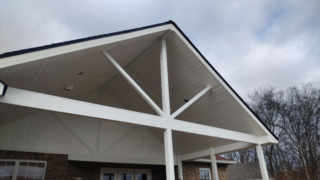 A newly constructed covered patio roof structure with white ceiling and beams by Affordable Home Improvement LLC in Pleasant View, TN.