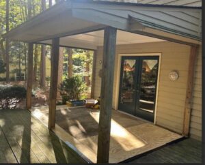 A covered porch and deck area under construction with plywood flooring, by X-Terior Techs in Henrico, VA.