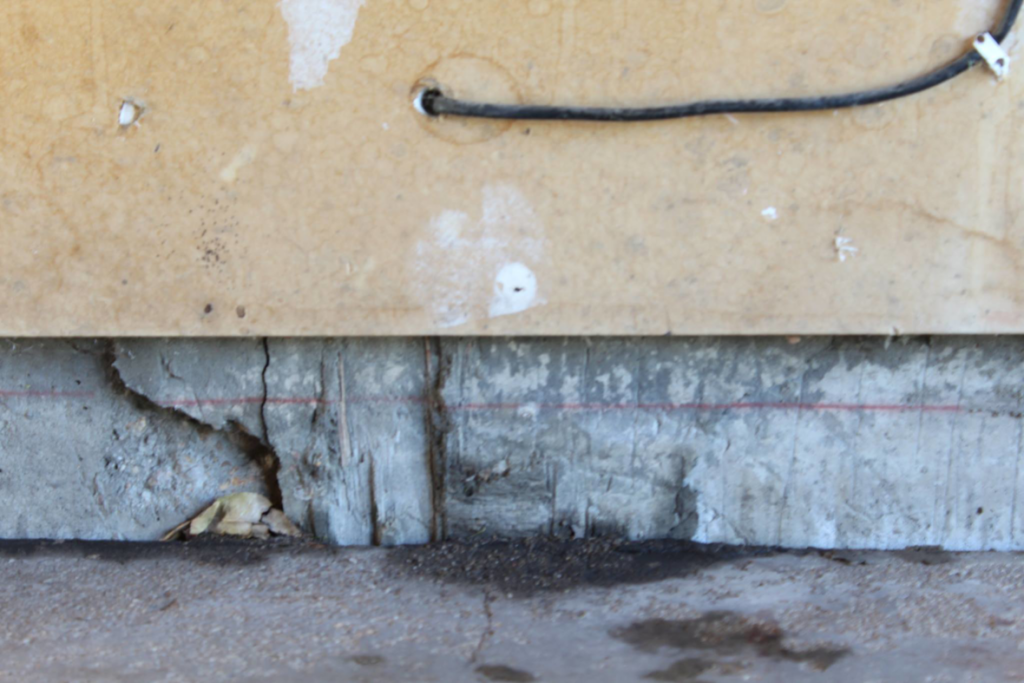 Severe cracks and damage visible in a concrete foundation or wall, requiring expert repair from American Mud Jack INC in Arvada, CO.