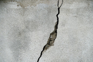 A large crack in a concrete wall, indicating a need for repair services from Abbot Building Restoration Co., Inc. in Boston, MA