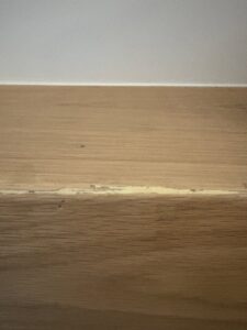 A detailed view of a cracked wooden surface, showing damage that Special Reserve Contracting can repair in Charlotte, NC.