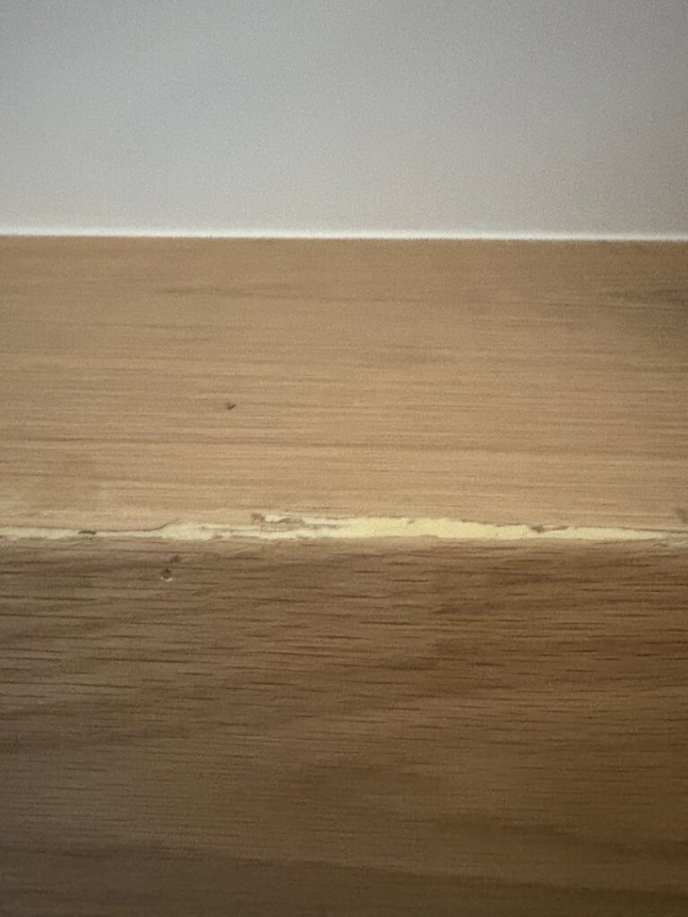 A detailed view of a cracked wooden surface, showing damage that Special Reserve Contracting can repair in Charlotte, NC.