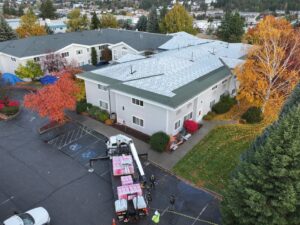 A crane delivering roofing materials to a large building for Proline Roofing in Shipshewana, IN.