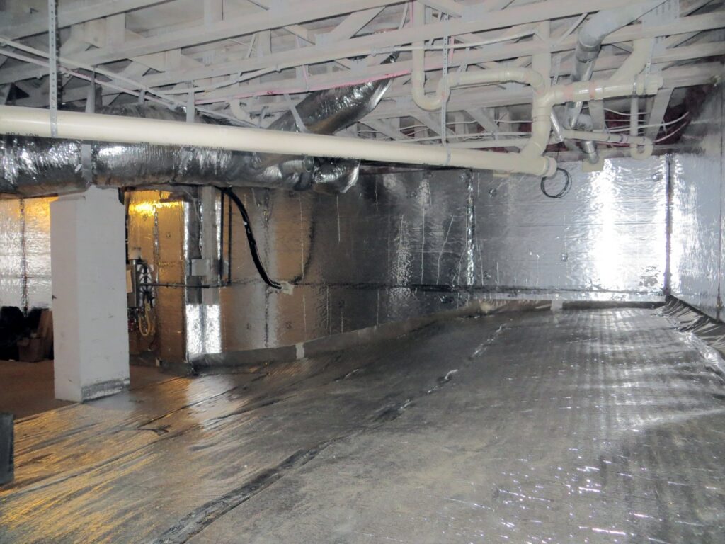 A sealed crawl space with a vapor barrier and insulation installed by Indoor Environmental Systems in Cary, NC.