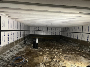 Crawl space insulation installation in progress, a service provided by Worths handyman services in Wasilla, AK.