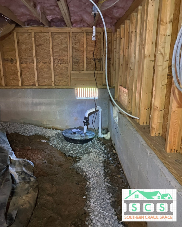 A newly installed sump pump and drainage system in a crawl space by Southern Crawl Space in Madison, AL.