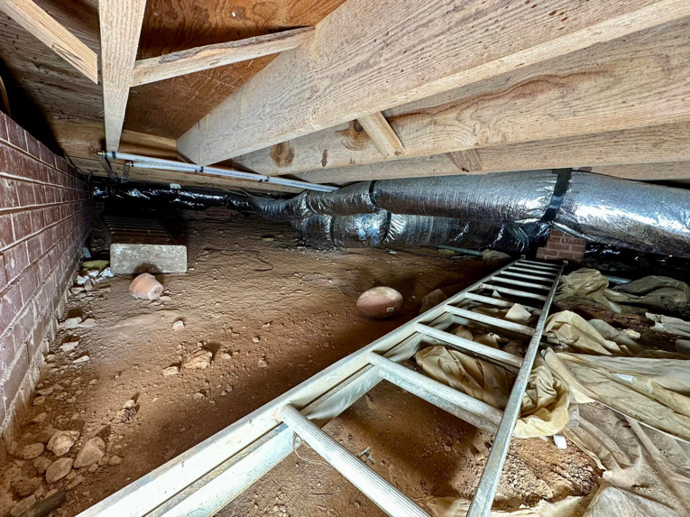 A crawlspace showing the preparation phase for waterproofing and sealing services by Ramos Waterproofing & Crawlspace Sealing LLC in Durham, NC.