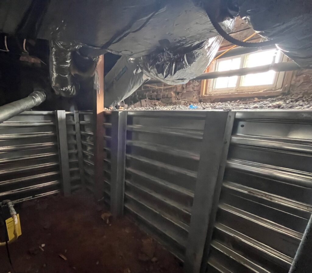 Metal retaining walls installed in a crawlspace for structural support by Appalachian Foundation Services in Roanoke, VA.