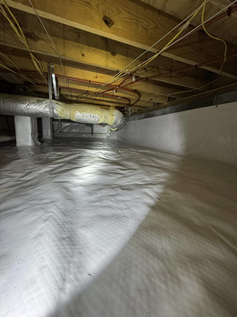 A completed crawlspace encapsulation with a white vapor barrier and insulated ductwork by Humidi-Seal Crawlspace Solutions in Charleston, SC.