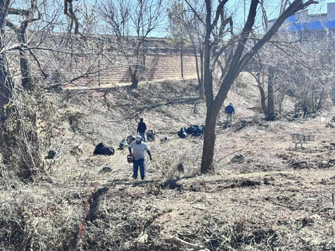 A crew clearing debris and brush from a construction site, demonstrating work by HCR, Inc. in Boerne, TX.
