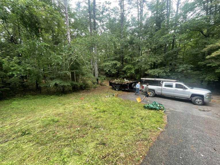 A crew from Mr. Property Service clearing yard debris and brush into a trailer in Sanford, ME.