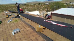 A crew installing roofing materials on a residential house by Villalobos Remodeling & Construction in El Paso, TX