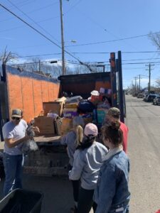A crew loading boxes and bags into the back of a Music City Removal truck during a junk removal job in Nashville, TN.