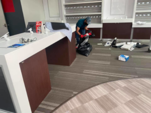 A crew member actively bagging junk during a commercial cleanout service by El Paso Junk Removal and Hauling in El Paso, TX.