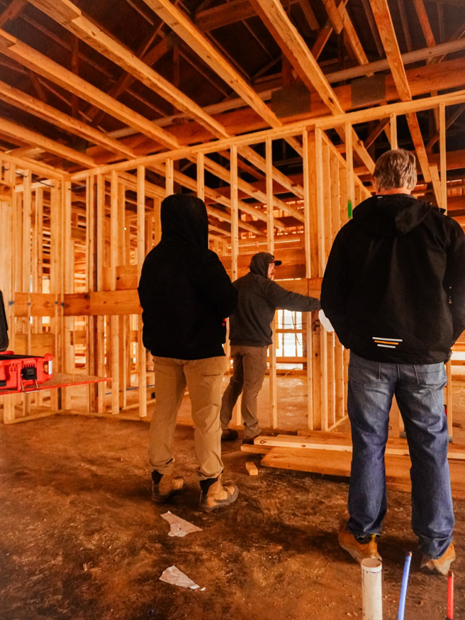 A crew working on the interior framing of a barndominium project by Nashville Barndo Builders in Franklin, TN.