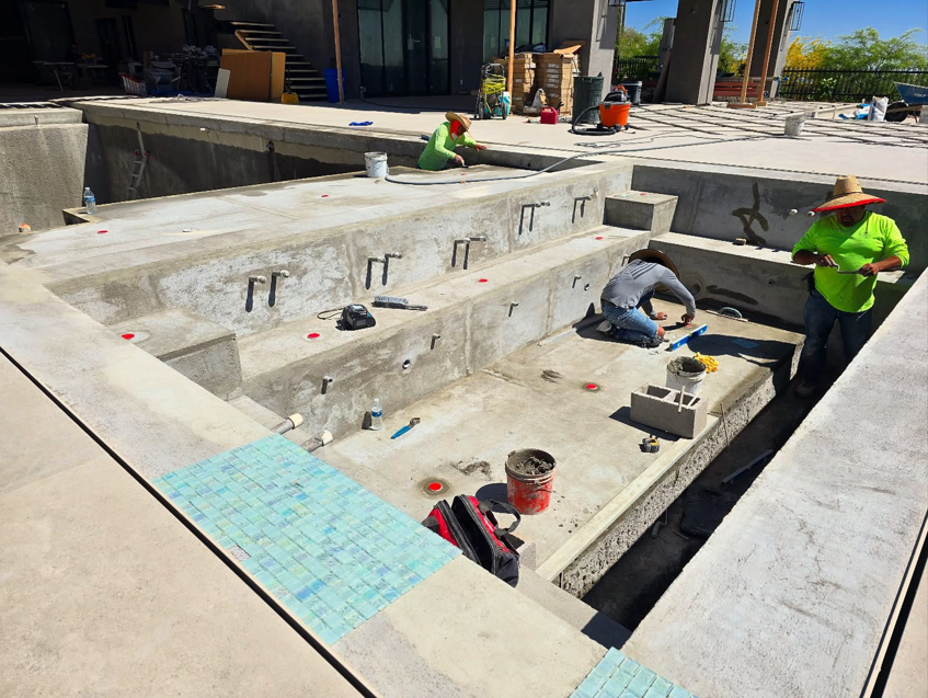 A crew of handymen working on pool construction and tiling for Premier Paradise, Inc. in Gilbert, AZ.