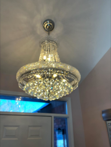 An ornate crystal chandelier professionally installed on a ceiling by GOAT Tv Mounting & Home Improvement L.L.C in Toledo, OH.