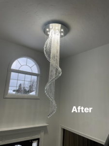 A stunning crystal chandelier expertly installed in a high ceiling by Ray's construction in St. George, UT.