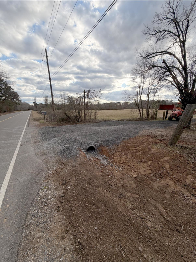 A newly installed culvert and gravel driveway entrance by S&B Construction Services in Shreveport, LA.
