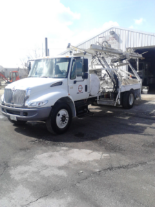 A specialized curb machine truck parked at National Kurb Kut in Naperville, IL, ready for general contractor work.