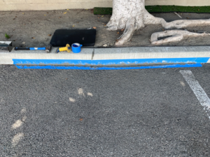 Tools and blue tape used for curb repair by Hollywood Handyman in Glendale, CA.