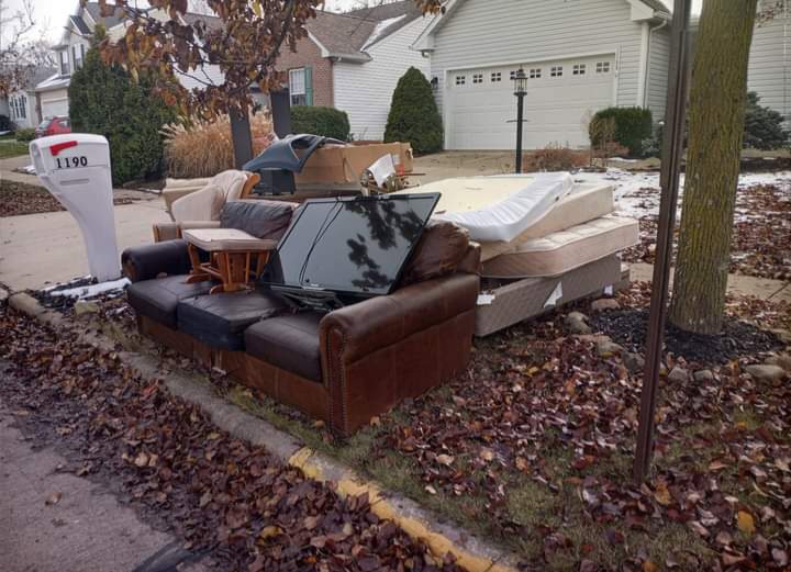 A curb-side pile of junk including a sofa, television, and mattress, awaiting pickup by HAULA Junk Removal in Canton, OH.