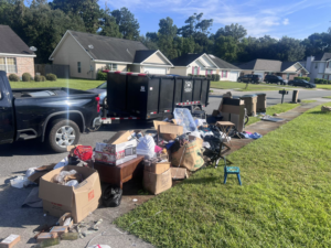 A large pile of household junk and boxes on a curb for removal by Won't Bash Your Trash in Savannah, GA.