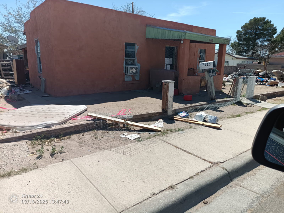 A curbside pile of junk including a mattress and various debris, ready for removal by Discount Hauling in Las Cruces, NM.