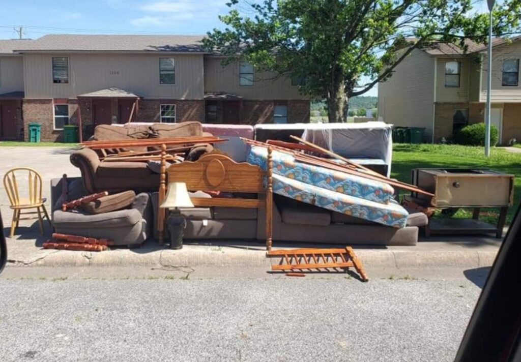 A large curbside pile of old furniture and mattresses, ready for pickup by Urban Junk Removal, LLC in Springdale, AR.