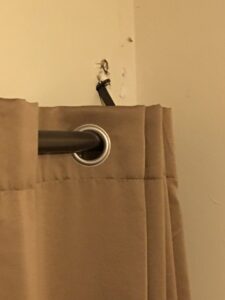 Damaged drywall where a curtain rod pulled out, a common repair by Honey Bee's Handyman Services in Hastings, NE.