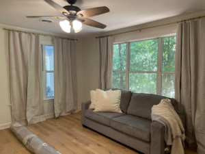 Professional curtain rod and ceiling fan installation in a living room by Berryhill Handyman and Home Preservation in Jonesboro, AR.
