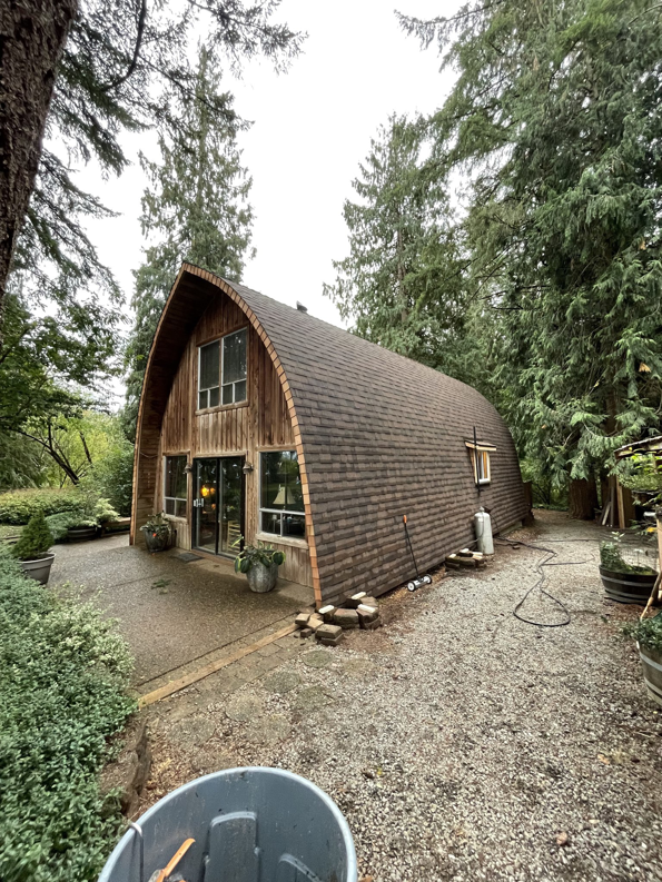 A unique house with a newly installed curved roof, showcasing exterior repair work by LETSA Construction LLC in Salem, OR.