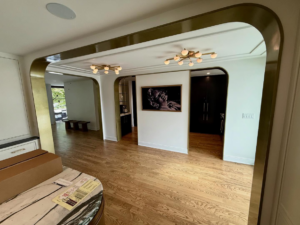 A beautifully finished interior with custom archway and built-in cabinetry by Red Beard Cabinets in Kansas City, MO.