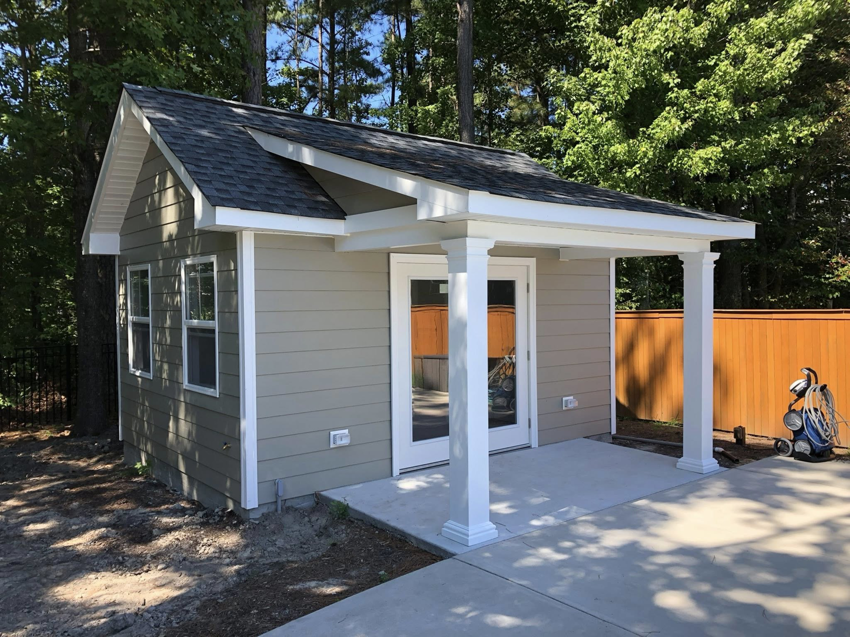 A custom-built backyard shed featuring a small covered porch, completed by RMG Construction in Chesapeake, VA.