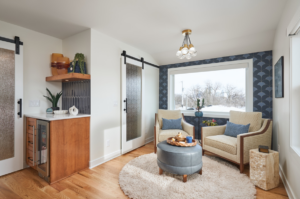A custom bar cabinet with floating shelves and sliding barn doors installed by EdgeWork Design Build in Minneapolis, MN.