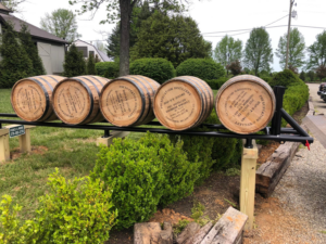 A custom-built display stand holding whiskey barrels, installed by Fence & More in Elizabethtown, KY
