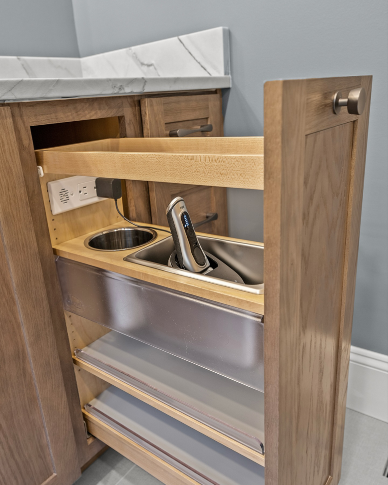 A custom pull-out bathroom cabinet drawer with an integrated electrical outlet installed by Blue Ribbon Residential Construction, Inc. in Raleigh, NC.