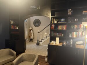 An interior room featuring custom-built black bookshelves and an arched doorway, renovated by M.M. Remodelers in Resaca, GA.