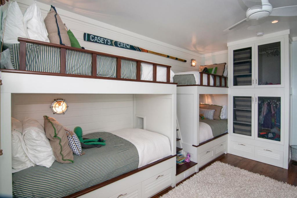 Custom-built bunk beds and a matching built-in wardrobe in a child's room by ArcherRead Woodworking in Wilmington, NC