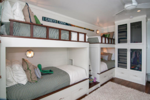 Custom-built bunk beds and a matching built-in wardrobe in a child's room by ArcherRead Woodworking in Wilmington, NC