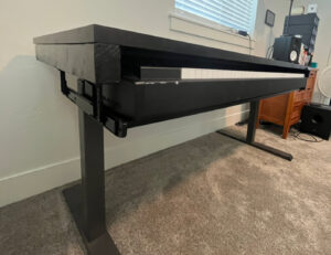 A custom-built desk featuring a pull-out keyboard tray, a carpentry service by Forever Young Handyman Services in Boise, ID.