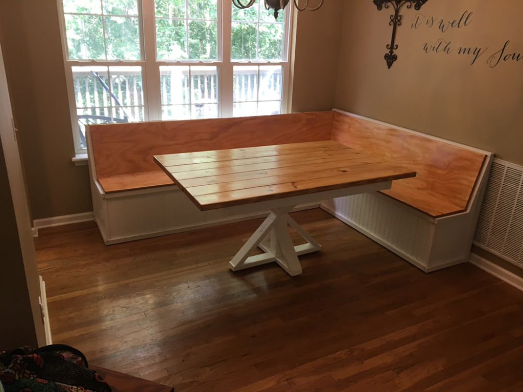A custom-built wooden dining nook with a table and bench seating by Davidson Handyman Services in Nashville, TN.
