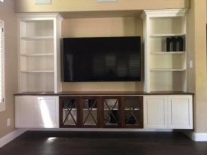 A custom-built entertainment center with shelving and TV mount by Celano Construction in Mesa, AZ