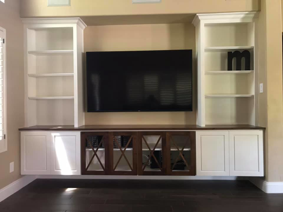 A custom-built entertainment center with shelving and TV mount by Celano Construction in Mesa, AZ