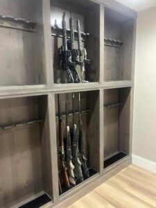 A custom-built wooden gun cabinet and display unit crafted by Renegade Woodworks in Kearney, NE.