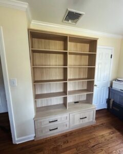 A custom built-in bookcase with adjustable shelves and lower storage drawers by Closet Creations Inc. in Sleepy Hollow, NY.