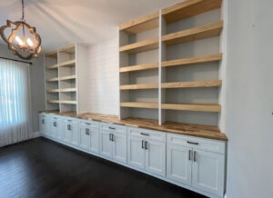 Custom built-in bookshelves and lower cabinets with wooden countertops, expertly crafted by Midwest Home Remodeling & Design LLC in Chicago, IL.